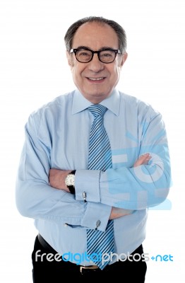 Senior Businessman With Folded Arms Stock Photo