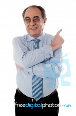 Senior Businessperson Pointing Away Stock Photo