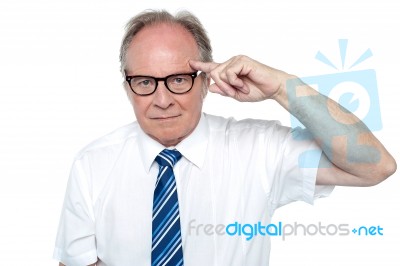 Senior Corporate Immersed In Deep Thoughts Stock Photo