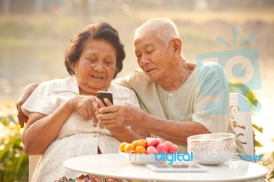 Senior Couple Using The Mobile Phone Stock Photo