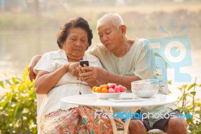 Senior Couple Using The Mobile Phone Stock Photo