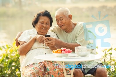 Senior Couple Using The Mobile Phone Stock Photo