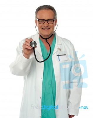 Senior Doctor holding Stethoscope Stock Photo