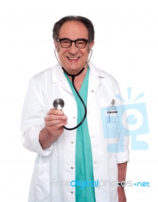 Senior Doctor Holding stethoscope Stock Photo