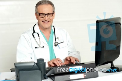 Senior Doctor Using Computer Stock Photo