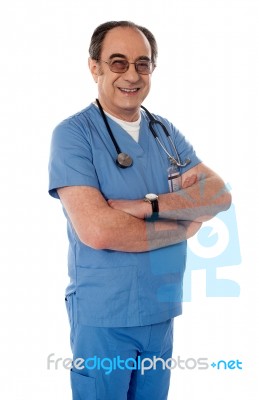 Senior Doctor With Arm Crossed Stock Photo