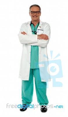 Senior Doctor With Arms Crossed Stock Photo