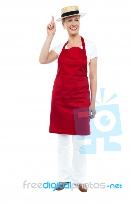 Senior Lady Chef Pointing Up Stock Photo