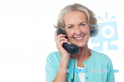 Senior Lady Holding Phone Receiver Stock Photo