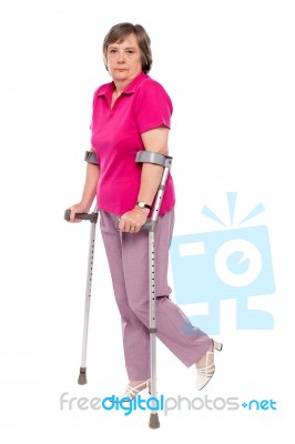 Senior Lady With Crutches Stock Photo