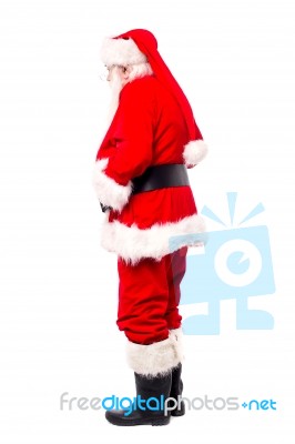 Senior Man In Santa Costume Turned Around Stock Photo