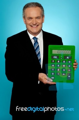 Senior Manager Showing Big Green Calculator Stock Photo