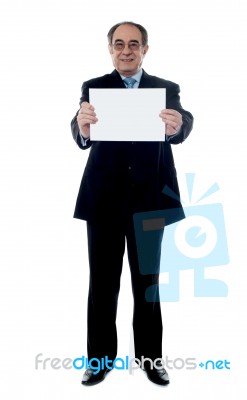 Senior Manager With Blank Billboard Stock Photo