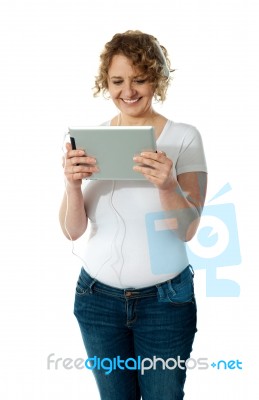 Senior Woman Enjoying Music Stock Photo