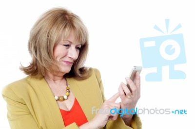 Senior Woman Looking At Her Cell Phone Stock Photo