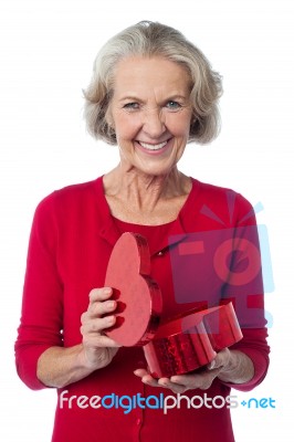 Senior Woman With Heart Shaped Gift Box Stock Photo