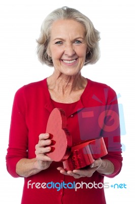 Senior Woman With Heart Shaped Gift Box Stock Photo