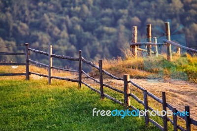 September Rural Scene In Mountains. Authentic Village And Fence Stock Photo