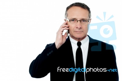 Serious Businessman Talking On The Phone Stock Photo