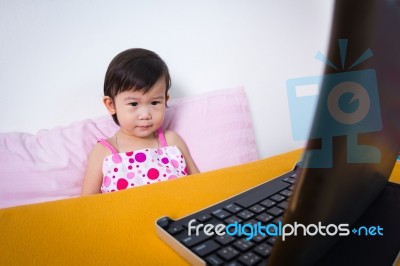 Serious Child Sitting And Looking A Story On Digital Tablet Comp… Stock Photo