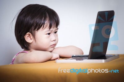 Serious Child Sitting And Looking A Story On Touchscreen Digital… Stock Photo