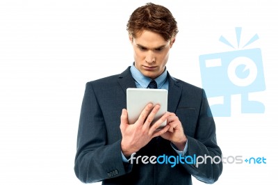 Serious Corporate Working On Tablet Pc Stock Photo