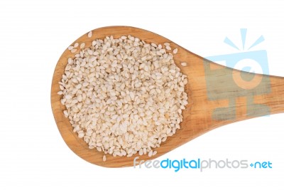 Sesame Seeds With Wooden Spoon On A White Background Stock Photo