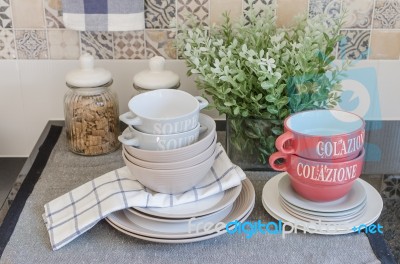 Set Of Plates And Dish On Counter In Kitchen Room Stock Photo