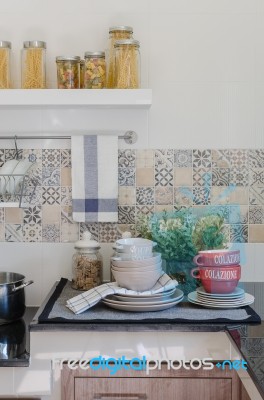 Set Of Plates And Dish On Counter In Kitchen Room Stock Photo