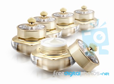 Several Golden Crown Cosmetic Jar On White Background Stock Photo