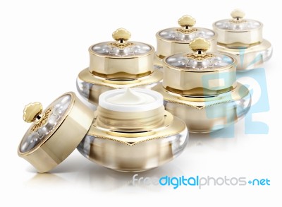 Several Golden Crown Cosmetic Jar On White Background Stock Photo