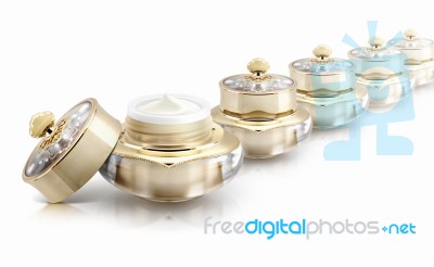 Several Golden Crown Cosmetic Jar On White Background Stock Photo