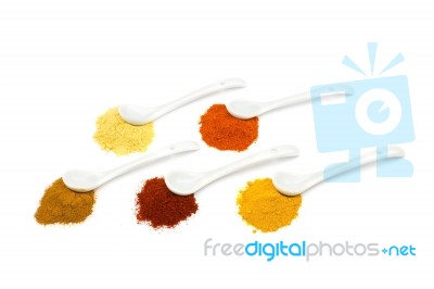 Several Seasoning Spices On Porcelain Spoons Stock Photo