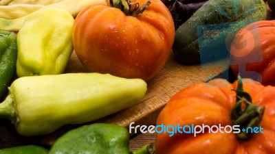 Several Vegetables On Wooden Chopping Board And Table Stock Photo