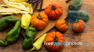 Several Vegetables On Wooden Chopping Board And Table Stock Photo