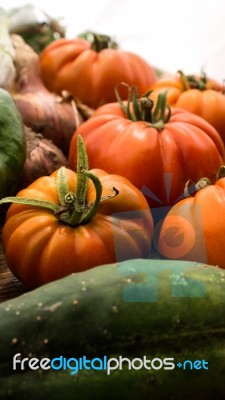 Several Vegetables On Wooden Chopping Board And Table Stock Photo