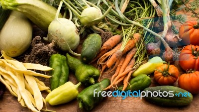 Several Vegetables On Wooden Chopping Board And Table Stock Photo