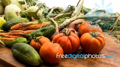 Several Vegetables On Wooden Chopping Board And Table Stock Photo