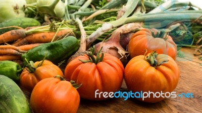 Several Vegetables On Wooden Chopping Board And Table Stock Photo