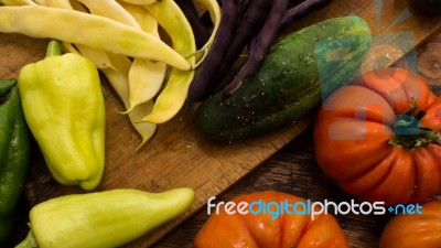 Several Vegetables On Wooden Chopping Board And Table Stock Photo