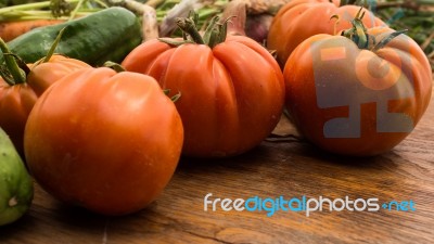 Several Vegetables On Wooden Chopping Board And Table Stock Photo