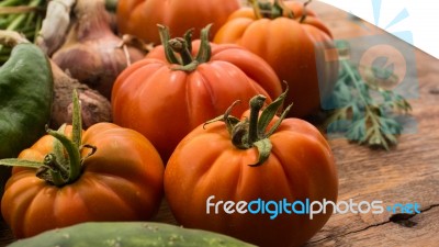 Several Vegetables On Wooden Chopping Board And Table Stock Photo