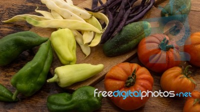 Several Vegetables On Wooden Chopping Board And Table Stock Photo