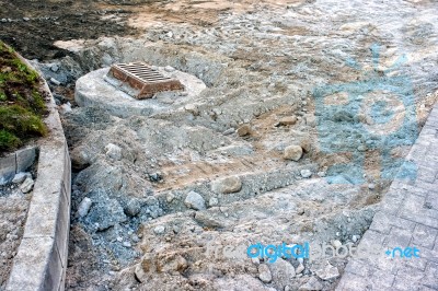 Sewer Hatch Building In New Road Stock Photo