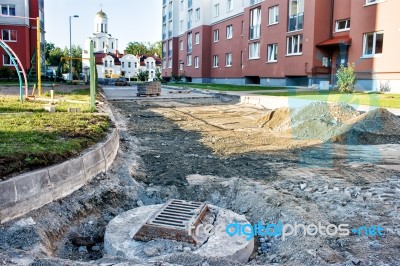 Sewer Hatch Building In New Road Stock Photo