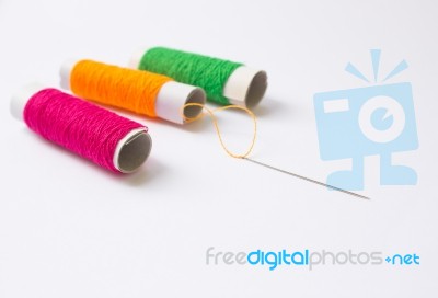 Sewing Threads And Needle Background Stock Photo