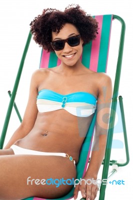 Sexy Bikini Model Seated On A Deckchair Stock Photo