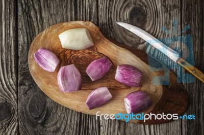 Shallot On The Wooden Board With Knife Top View Stock Photo