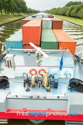 Ship Carrying Containers On Canal Stock Photo