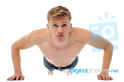 Shirtless Guy Doing Push Ups On The Floor Stock Photo